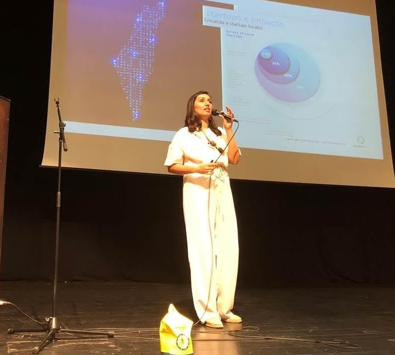 Ale Barav speaking on stage at the College of Management